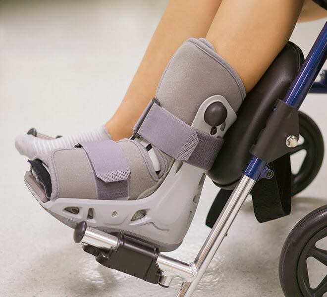 close up of patient in wheelchair wearing medical boot