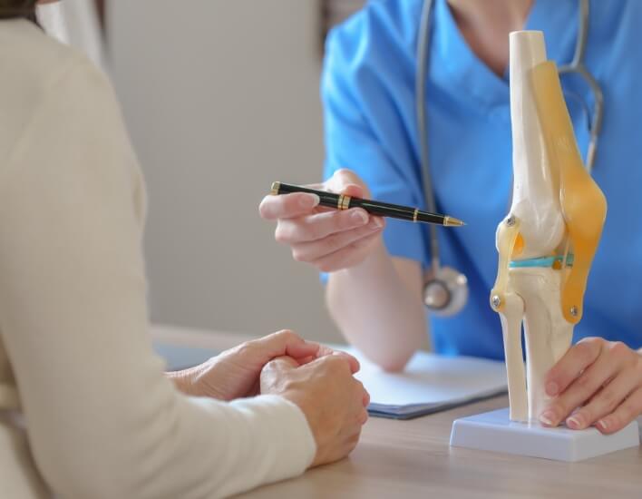 doctor consulting patient using bone diagram