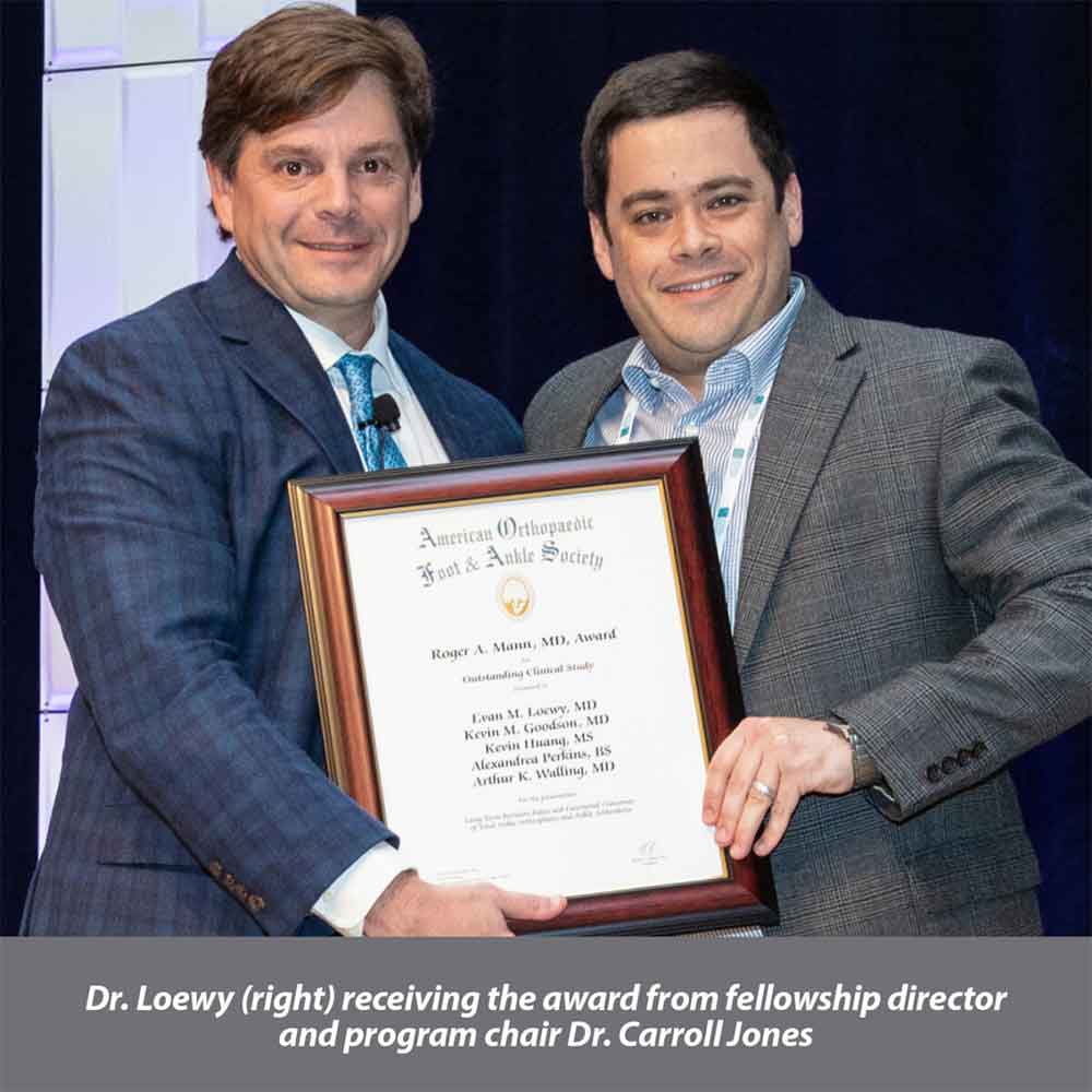 Dr. Evan Loewy accepting prestigious award