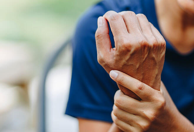 Closeup woman with carpel tunnel disease wrist pain