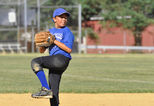 Little League player with an elbow growth plate injury