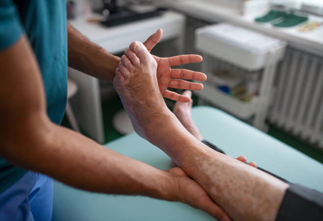 A joint specialist examines patient with bunions