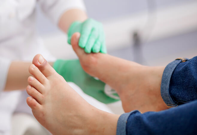 Doctor examines patient's foot