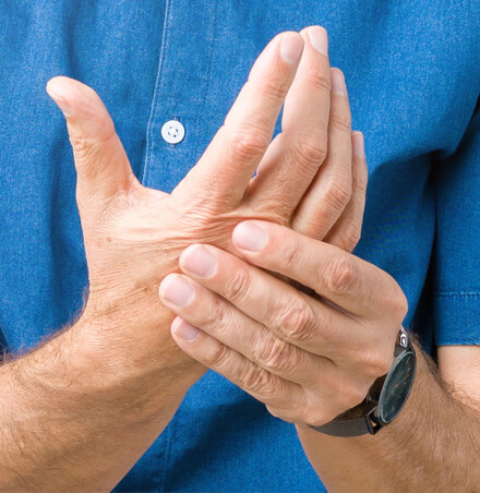 close-up of person rubbing hand