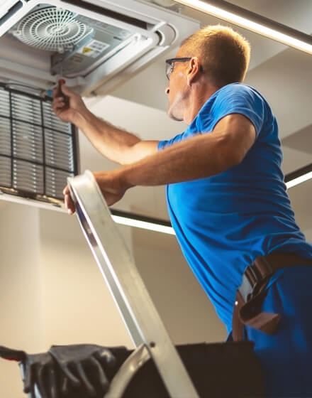 technician working on open ceiling vent