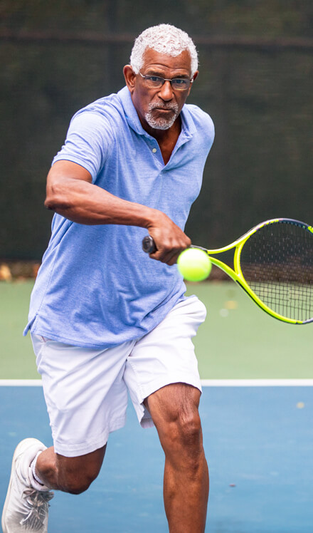 man actively playing tennis