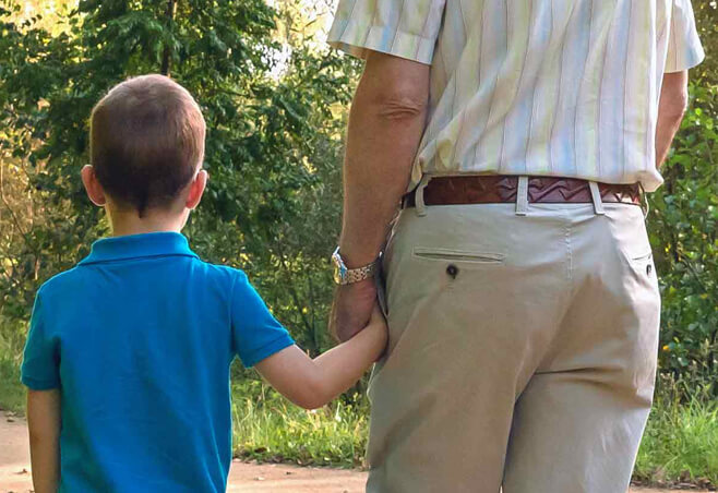 Grandfather walking with grandson