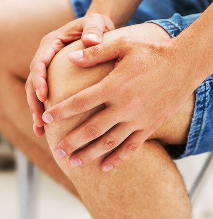 close-up of person holding knee