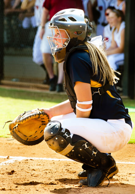 girl in umpire uniform at home plate