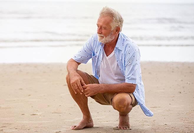 Man kneeling on the beach