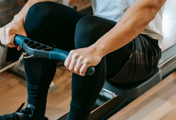 man using rowing machine