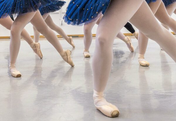 ballerinas dancing with knees bent and toes pointed