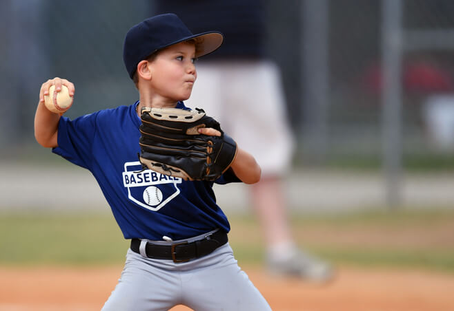 Young baseball player with Little Leaguer's elbow