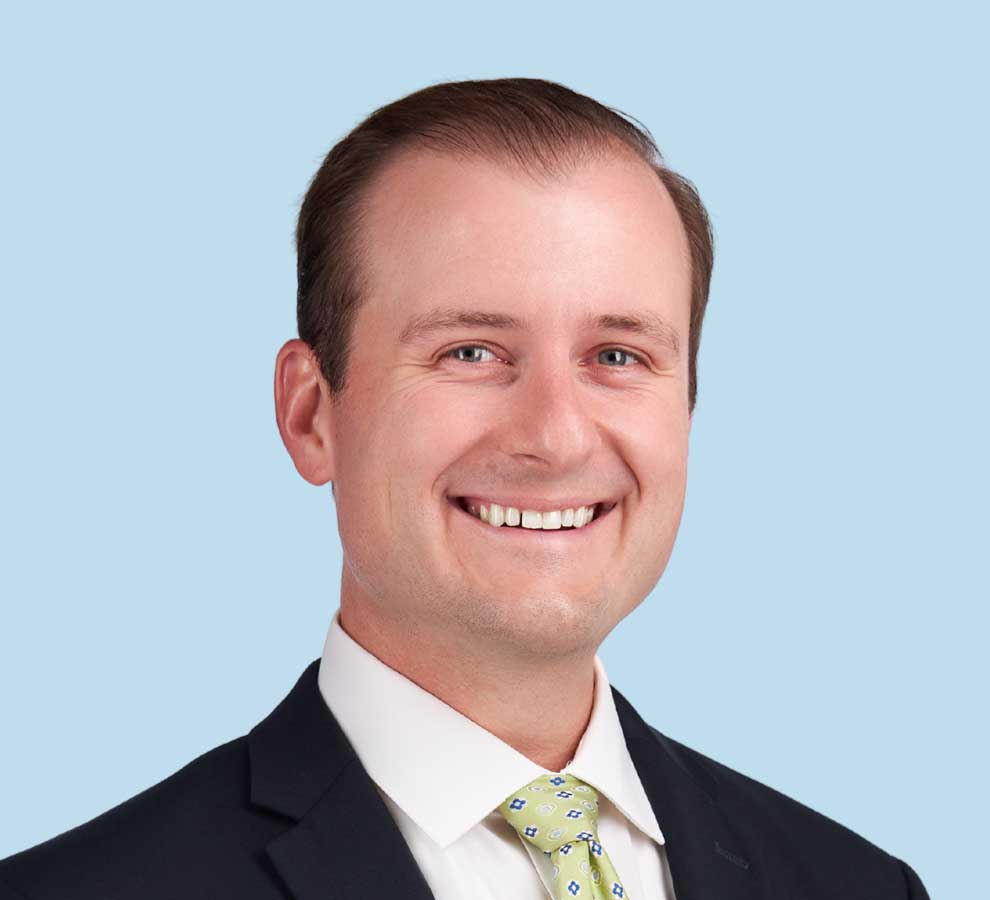 Benjamin Streufert, MD professional headshot wearing black suit with yellow patterned tie