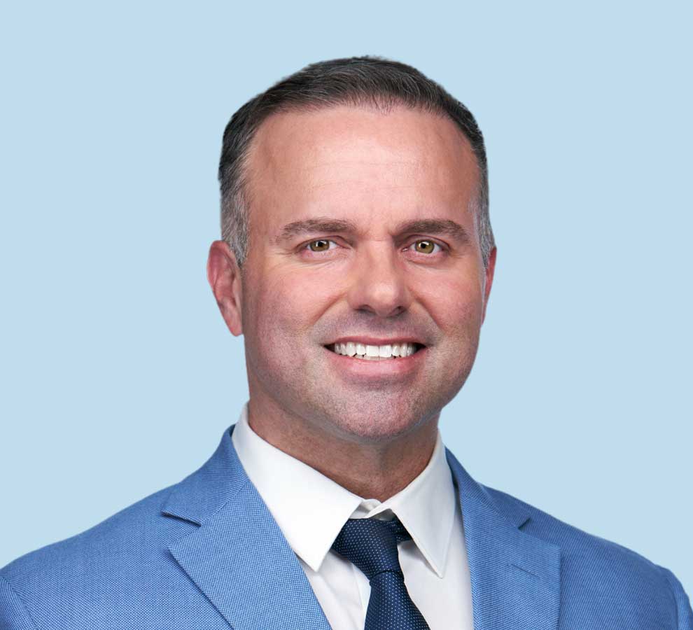 Brian T. Palumbo, MD professional headshot wearing bright blue suit with navy blue tie