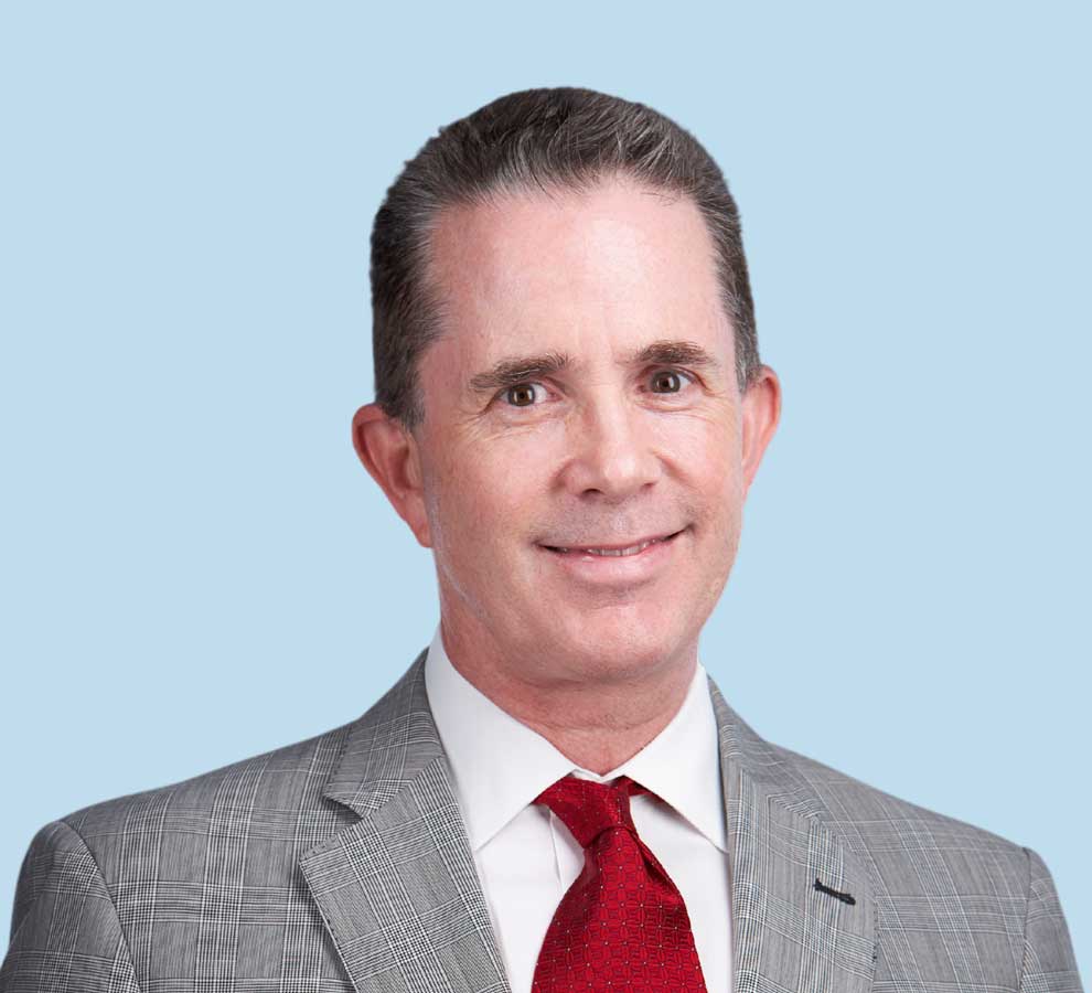 Charles C. Nofsinger, MD professional headshot wearing gray suit and bright red tie