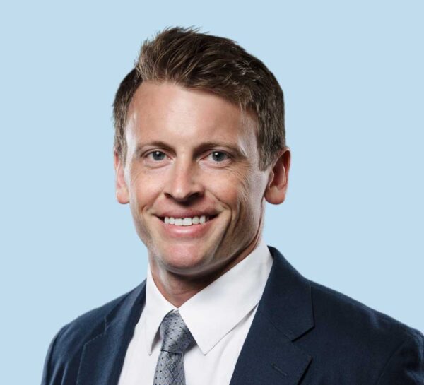 Christian D. Reintgen, MD professional headshot wearing black suit with textured gray tie