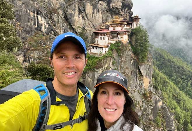 Dr. Craig Radnay adventurous travel with wife selfie with a distant temple in background