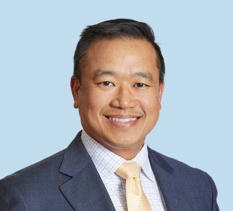 David Cheong, MD professional headshot wearing black suit and yellow tie