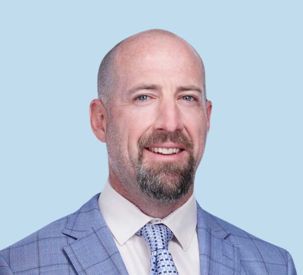 David T. Watson, MD professional headshot wearing plaid blue suit with textured blue tie