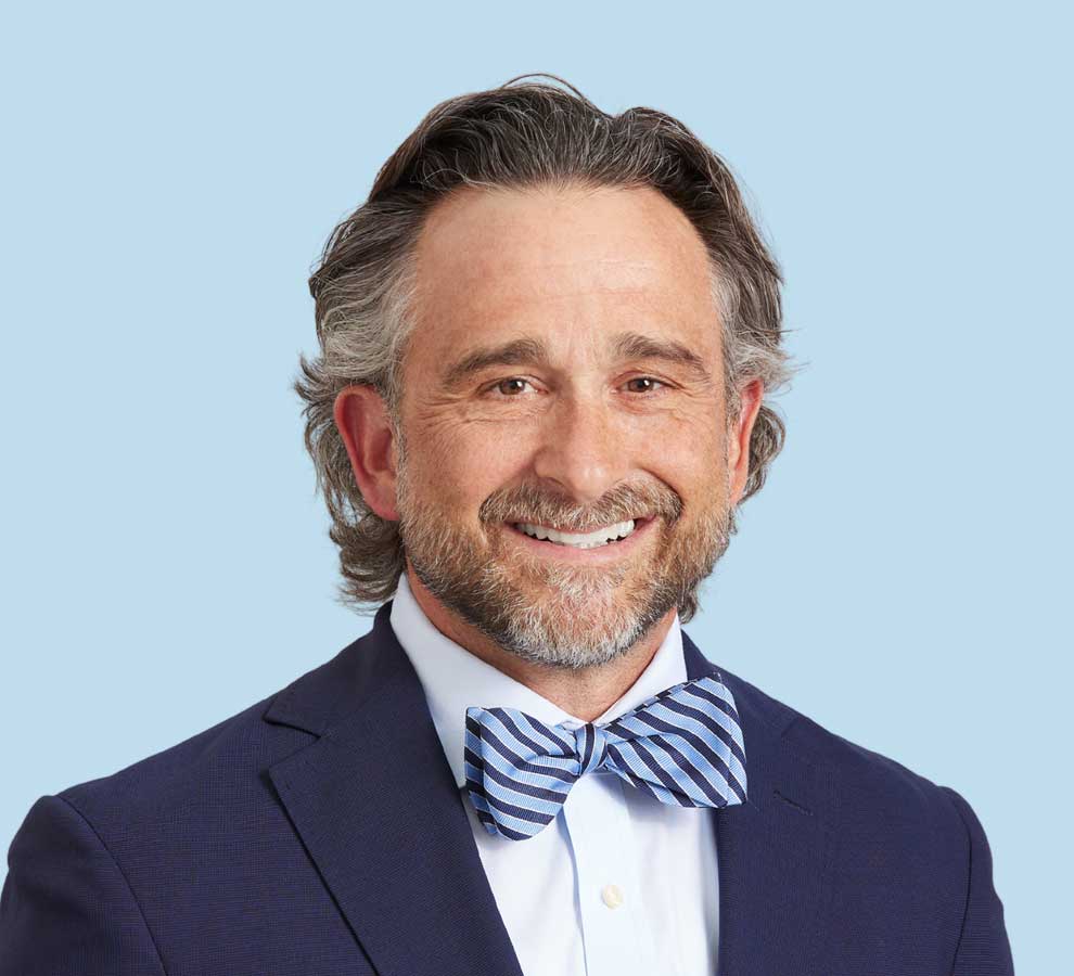 David Whiddon, MD professional headshot wearing dark navy suit with blue striped bowtie