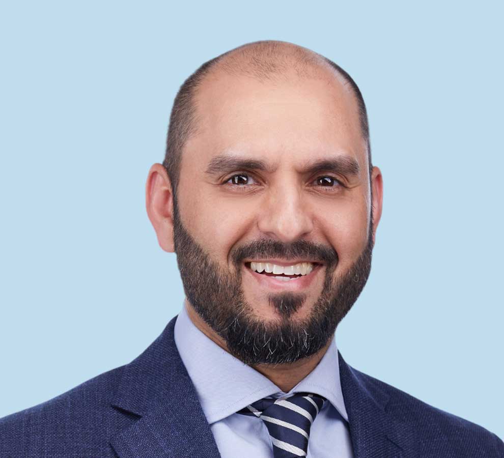 Faisal A. Chaudhry, MD professional headshot wearing blue suit and striped tie