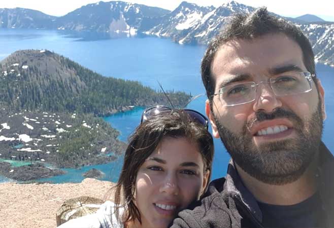 Dr. Georges Haidamous with beautiful areal view of mountains and lake