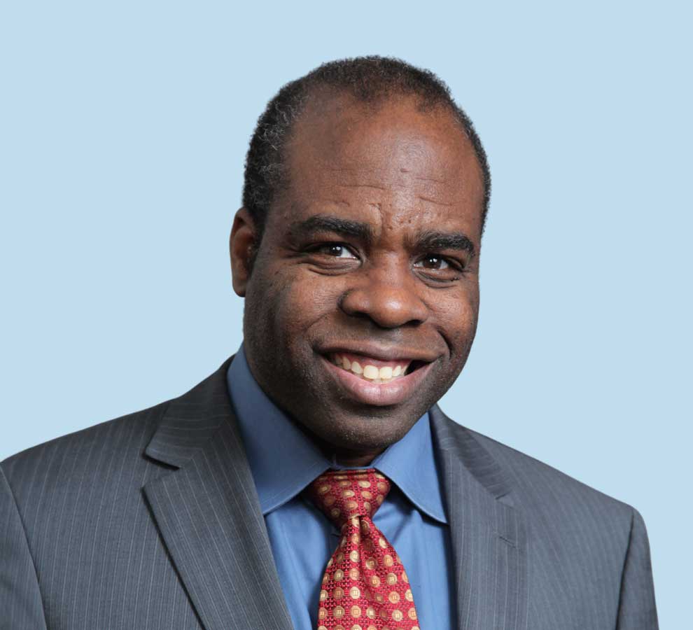 Howard B. Jackson, MD professional headshot wearing gray suit with a red tie