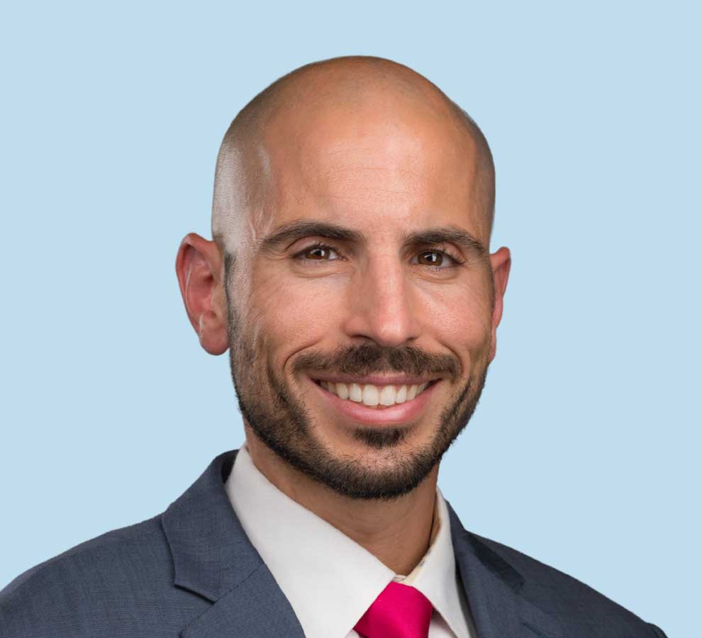 Ioannis P. Pappou, MD professional headshot wearing dark gray suit and bright red tie