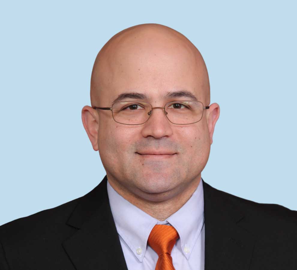 Jason A. Nydick, DO professional headshot wearing black suit with orange tie