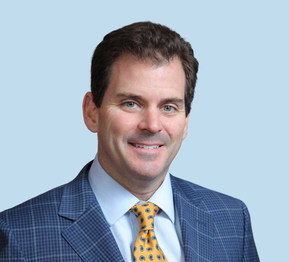 Jeffrey D. Stone, MD professional headshot wearing plaid blue suit and yellow paisley tie