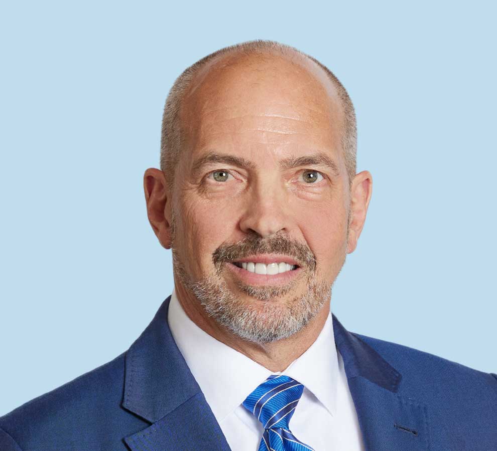 John Kilgore, MD professional headshot wearing blue suit and striped tie