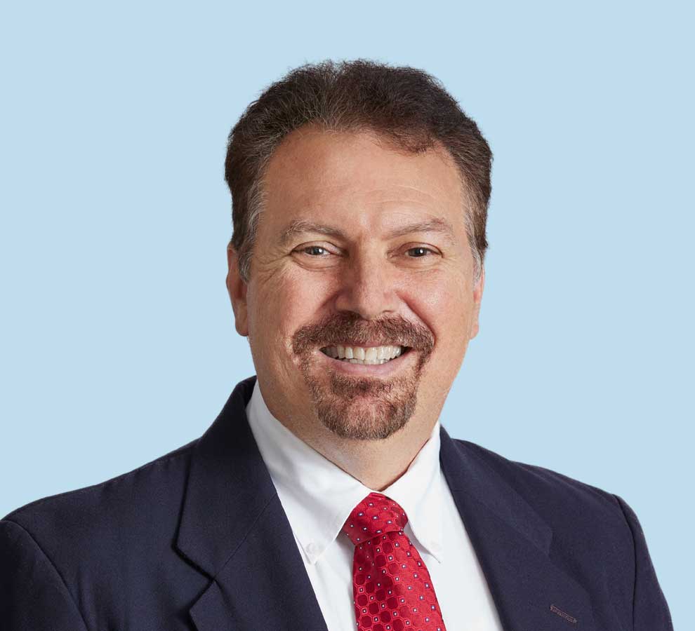 Jorge Rodriguez, MD professional headshot wearing black suit and red tie