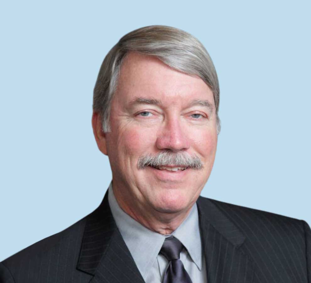 Kenneth A. Gustke, MD professional headshot wearing black suit and dark gray tie