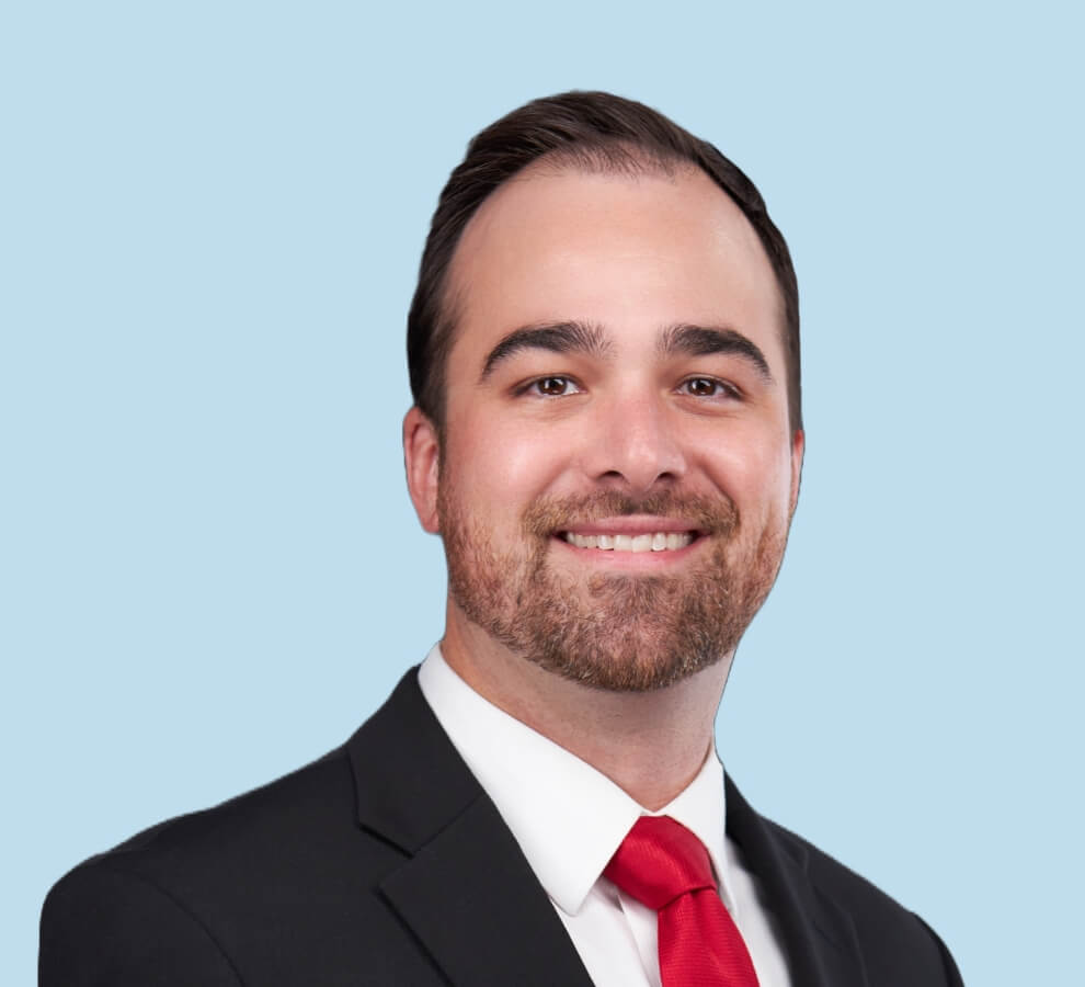 Kevin J. Cronin, MD professional headshot wearing black suit and bright red tie