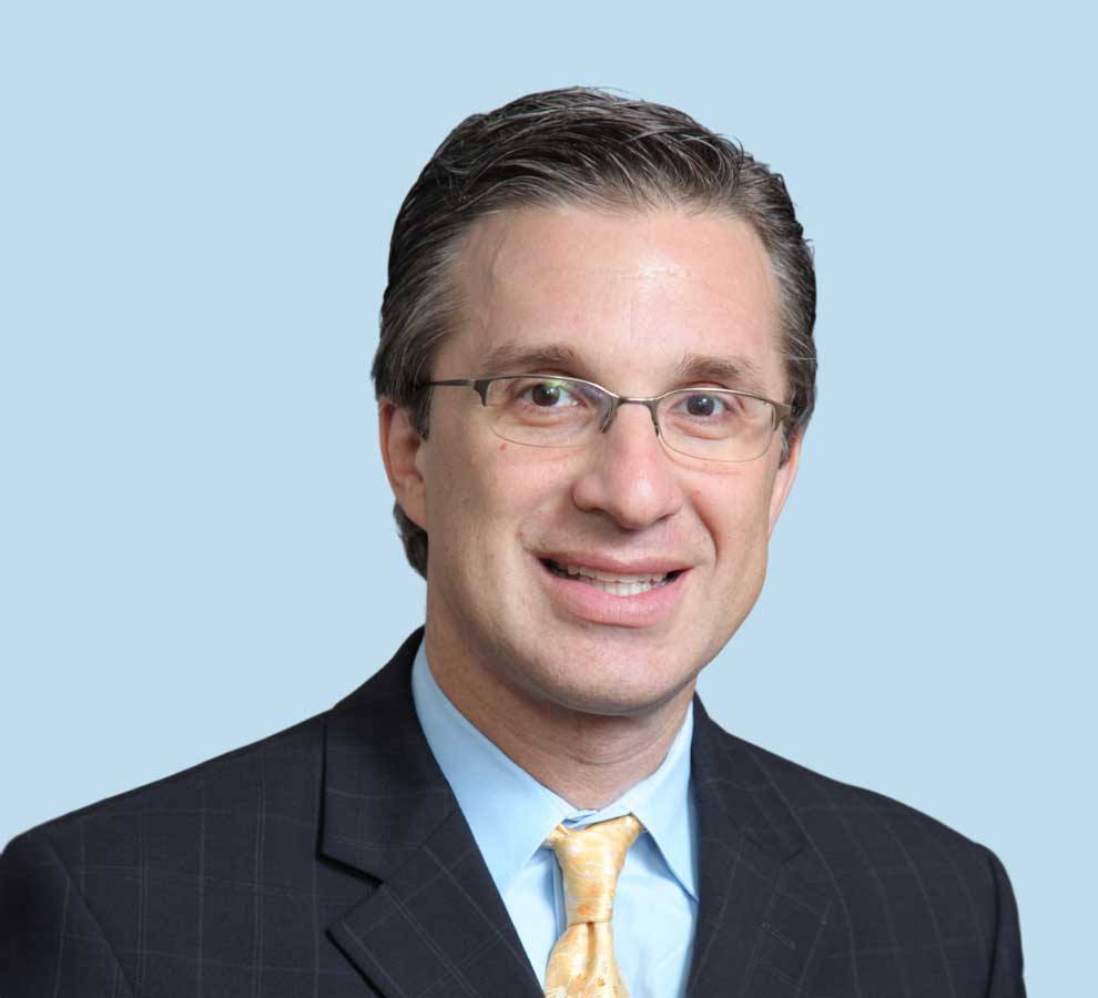 Marc A. Weinstein, MD professional headshot wearing black suit with yellow tie