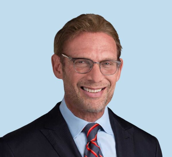 Mark A. Frankle, MD professional headshot wearing black suit and red striped tie