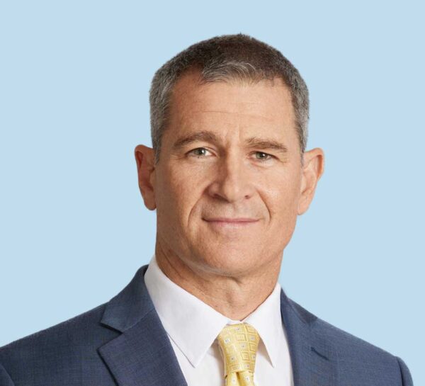 Matthew Swick, MD professional headshot wearing dark blue suit with yellow tie