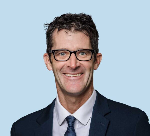 Michael Seth Smith, MD professional headshot wearing black suit and blue tie