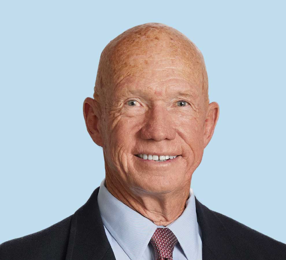 Michael Smith, MD professional headshot wearing black suit and red patterned tie