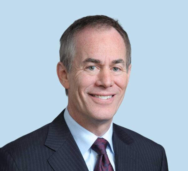 Roy W. Sanders, MD professional headshot wearing black suit and red paisley tie