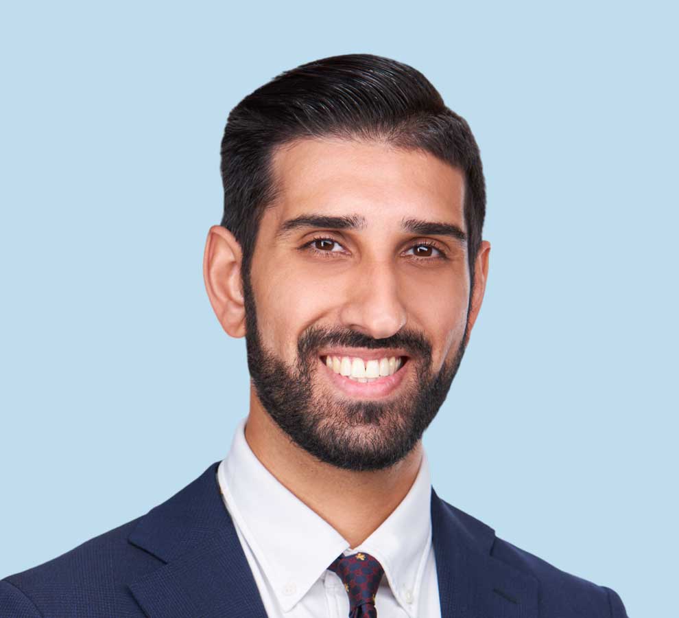 Shaan Mehta, MD professional headshot wearing navy blue suit with red checkered tie