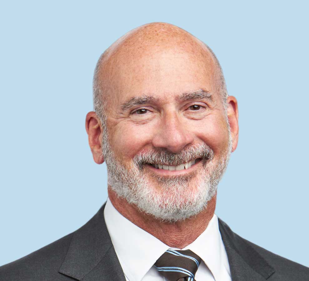 Steven J. Tresser, MD professional headshot wearing dark gray suit with striped tie