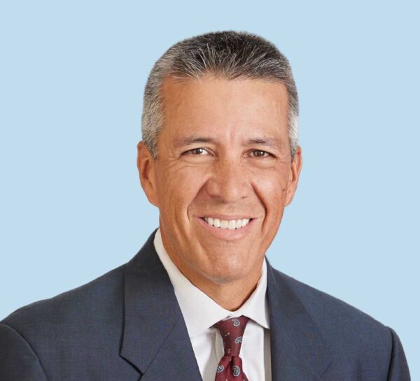 William Cottrell, MD professional headshot wearing black suit with maroon paisley tie