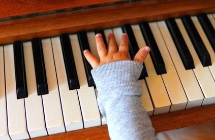 kid playing piano