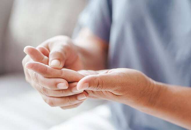 Up close person holding rheumatoid arthritis hands from pain