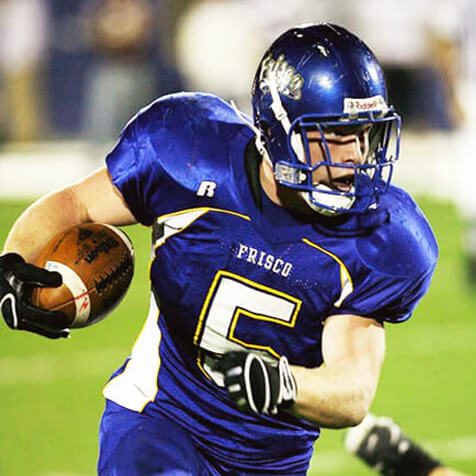 football player running the ball down the field