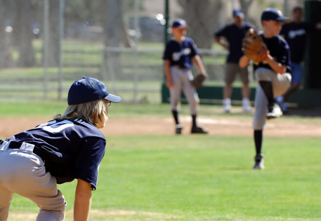 Little League players on the field during a game