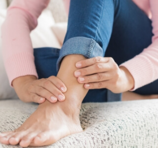 close up view of woman rubbing ankle