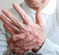 close up view of man holding sore hand